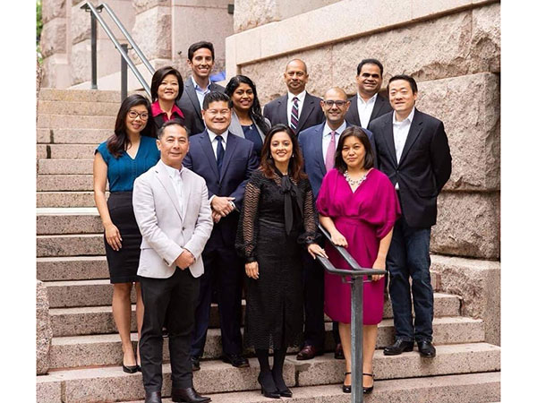 Jason Luong with a crowd of professionals on a staircase outdoors